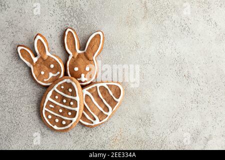Tasty Easter cookies on a grey table. Bunnies and eggs cookies for holiday,top view and copy space. Stock Photo