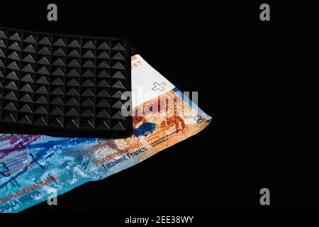 100 swiss franc banknote in a black wallet isolated. Stock Photo