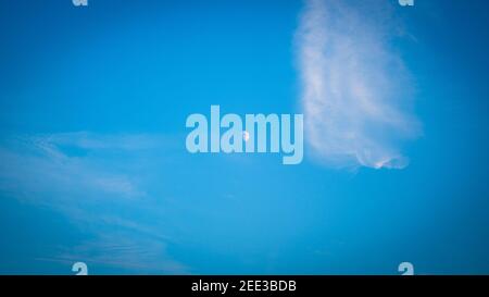 Daytime View of the sky over Suffolk Uk, the mood is visible and there are clouds Stock Photo