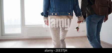 Unrecognizable young couple with keys moving in new flat, new home and relocation concept. Stock Photo