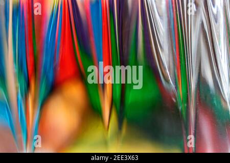 Colorful streaks of light trying to create their own signature through glass when captured with another glass (lens) Stock Photo