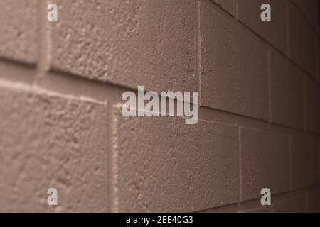 Decorating the wall with brick-shaped plaster. Beige wall, selective focus. Stock Photo
