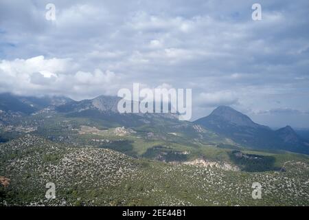 Peaks of rocky cliffs above the grassy slopes. Stock Photo