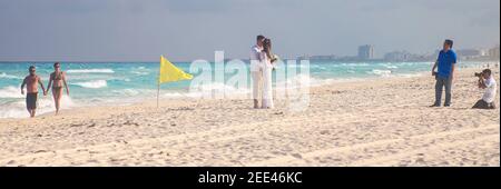 Romantic couple and photographers on beach Cancun, Quintana Roo, Mexico Stock Photo