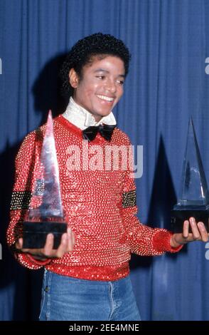 Michael Jackson carries the two American Music Awards he won for his album 'Off the Wall,' they are for Favorite Male Vocalist - Soul and R&B, and Favorite Album - Soul and R&B, Los Angeles, January 30, 1981. Credit: Ralph Dominguez/MediaPunch Stock Photo