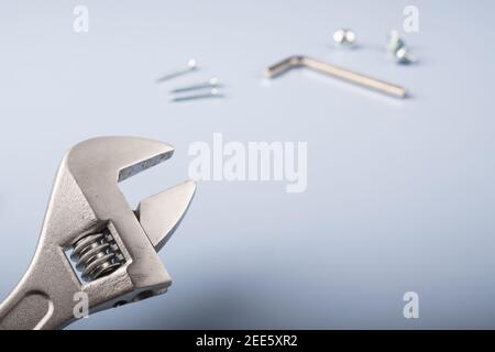 Wrench and other working tools on a light blue background Stock Photo