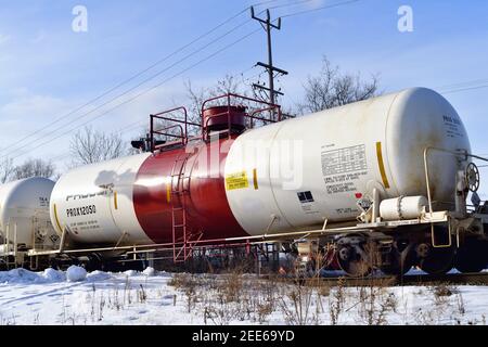 Barrington, Illinois, USA. A tank car designed to carry hazardous materials is identified by its white body and wide red stripe at the dome. Stock Photo