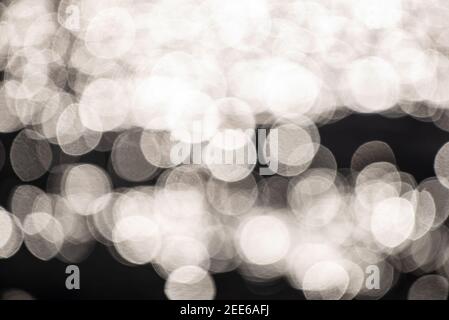 Bokeh of glittering sun on river waves Stock Photo