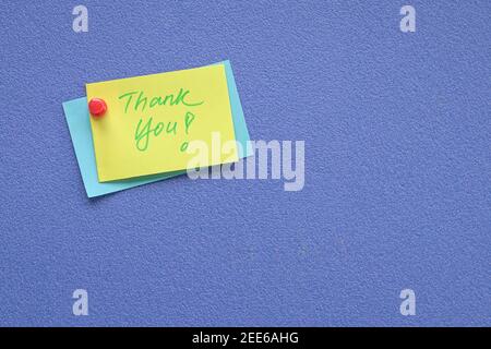 Thank you note pin on blue board. Copy space. Stock Photo