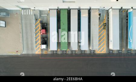 Looking down on trailers unloading goods at the warehouse Stock Photo
