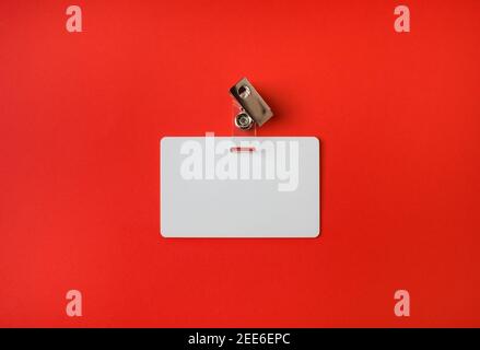 Photo of blank white plastic badge on vintage wooden table background ...