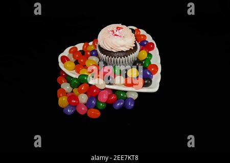 Strawberry Cupcake on Heart Shaped Plate with Candy Stock Photo