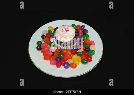 Strawberry Cupcake on Round White Plate with Candy Stock Photo