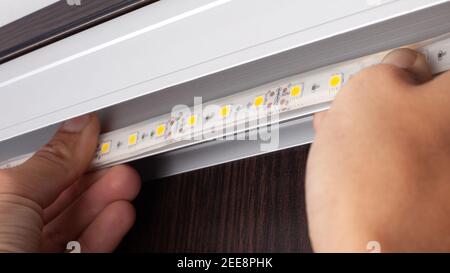 LED strip installation,installation of a diode tape Stock Photo