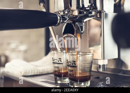 Coffee being brewed by the machine flowing through portafilter