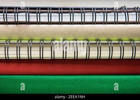 Spines of books and ring binder notebooks in stack, close up shot Stock Photo