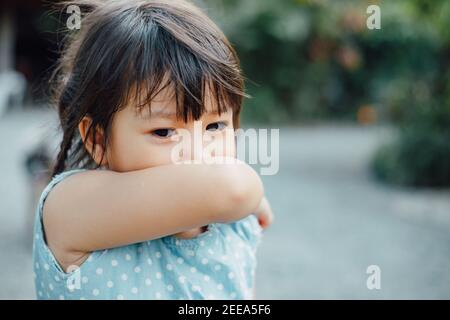 Kids in posture of elbow cough which is correct sneezing. Picture with copy space for concept of stop and prevention covid-19 or coronavirus spreading Stock Photo