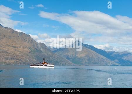 Queenstown New Zealand - March 1 2015; TSS Earnslaw tourist passenger classic steamship cruising across lake loaded with passengers sightseeing. Stock Photo