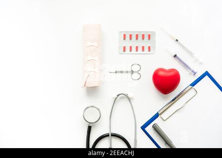 Medical instruments with red heart shape on white background, top view with copy space Stock Photo