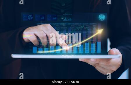 Businessman investment consultant analyzing company financial report statement working with digital augmented reality graphics. Stock Photo