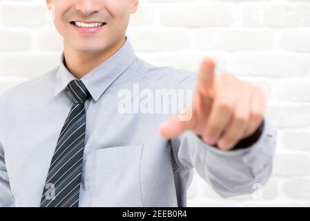 Smiling businessman hand touching on empty imaginary virtual screen Stock Photo