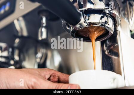 Close-up of espresso machine and shot glasses during a pour Stock Photo -  Alamy