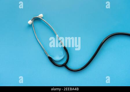 Medical instrument stethoscope on light blue background Stock Photo