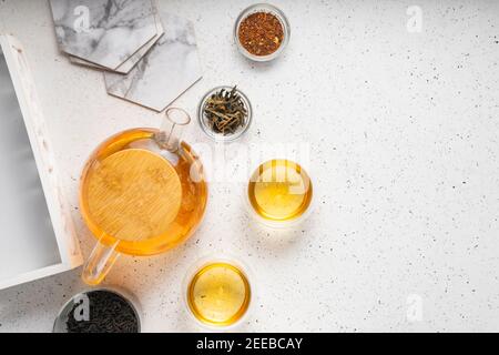 light tea flatley. pour black tea into thermos cups, on a light background. tea ceremony with different types of leaf tea Stock Photo