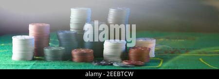 stacks of chips for casino but green background. Stock Photo