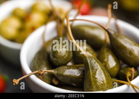 Green pickled Capers. Italian food ingredients. Stock Photo