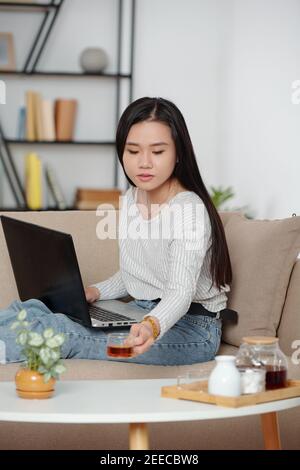Young woman working on laptop Stock Photo