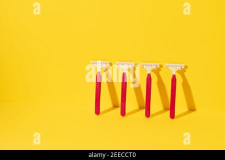 Studio shot of disposable razor tools on yellow Stock Photo