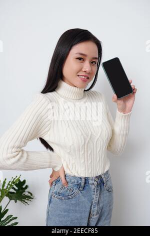 Young woman showing smartphone Stock Photo