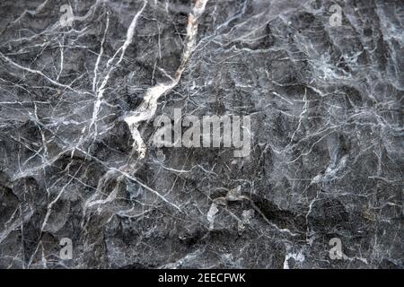 Grey stone surface with white veins ornament. Distressed stone surface. Rustic material template. Grey mineral surface. Natural marble stone backgroun Stock Photo