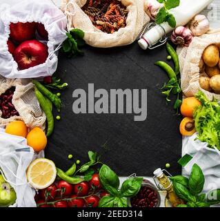 Zero waste shopping and sustanable lifestyle concept, various farm organic vegetables, grains, pasta and fruits in reusable packaging supermarket bags Stock Photo