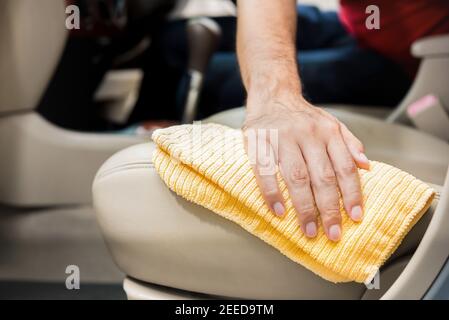 Closeup leather car interior cleaning with foam detergent and