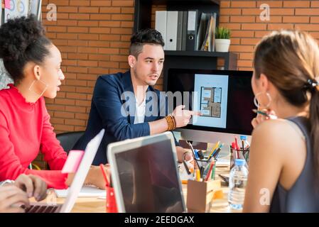 Multiethnic architects or interior designer team discussing project together in the meeting Stock Photo