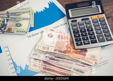 US Dollar and  Russian Ruble money on inflation and exchange rate graphs Stock Photo