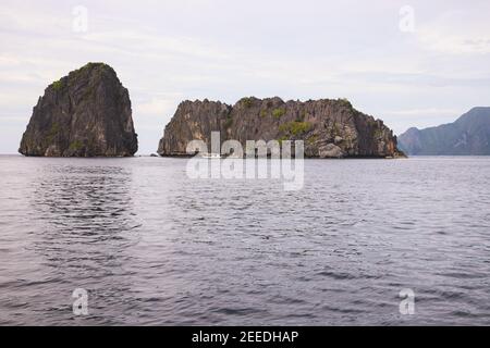 Rocky island in sea, neutral photo from tropical vacation. Philippines holiday. Unusual tropical landscape with sea and mountain. Summer travel in Asi Stock Photo