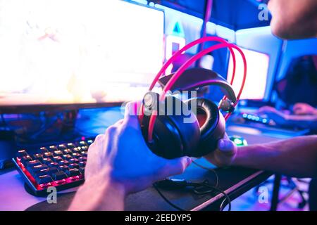 Streamer beautiful man regrets losing professional gamer loser playing online games computer, neon blue color. Stock Photo