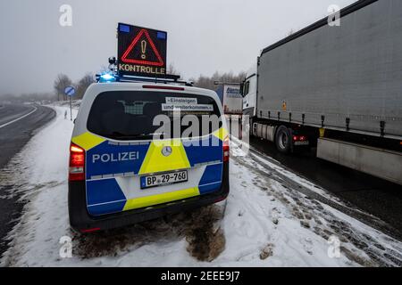 Waidhaus, Germany. 16th Feb, 2021. A police car announces a check at the German-Czech border in the early morning. Germany's tightened entry rules at the border with the Czech Republic to protect against dangerous variants of the coronavirus came into force in the night of 14.02.2021. Credit: Armin Weigel/dpa/Alamy Live News Stock Photo