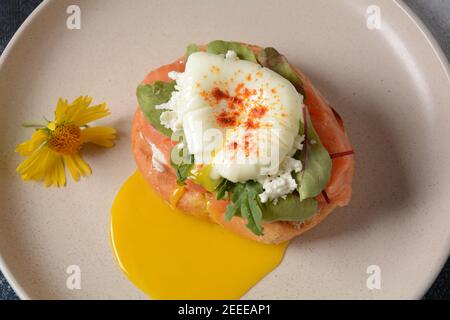Breakfast with sandwich with cereals bread and salmon, soft cheese and poached eggs Stock Photo