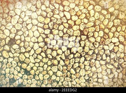 Yellow stone abstract background, retro toned photo. Tiny marble gravel template. Pebble texture. Marine or seaside construction material. Stone mosai Stock Photo