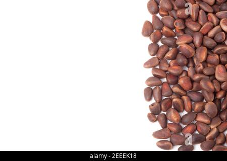 unpeeled pine nuts on a white background Stock Photo