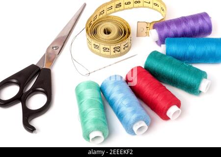 thread sewing needle centimeter scissors on a white background Stock Photo