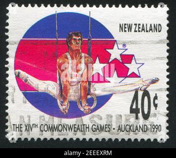 NEW ZEALAND - CIRCA 1989: stamp printed by New Zealand, shows Gymnast at 14th Commonweath Games in Auckland in 1990, circa 1989 Stock Photo