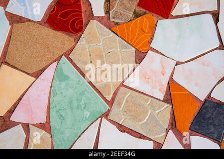 Multicolor ceramic mosaic floor. Creative recycled mosaic top view photo. Bathroom or kitchen floor design idea. Blue yellow ceramic tiles. Reused bro Stock Photo
