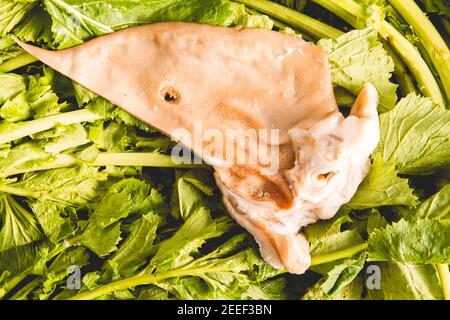salted pork ear cut naturally on turnip tops Stock Photo