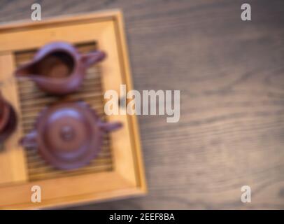 Japanese tea ceremony. Rustic tea pot on wooden table. Way of tea blurred photo background. Traditional tea drinking concept. Simple pottery top view Stock Photo