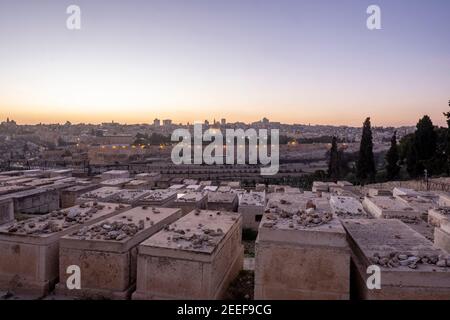 View across the Jewish Cemetery on the Mount of Olives toward the Dome of the Rock in the Temple Mount known to Muslims as the Haram esh-Sharif in the Old City East Jerusalem Israel Stock Photo